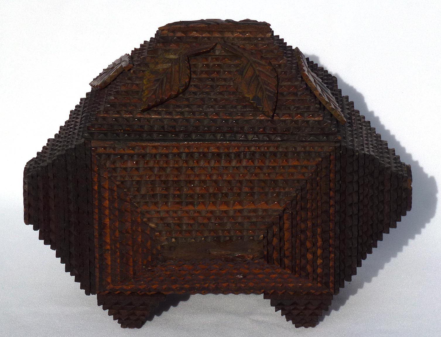 Tramp art box with carved leaves