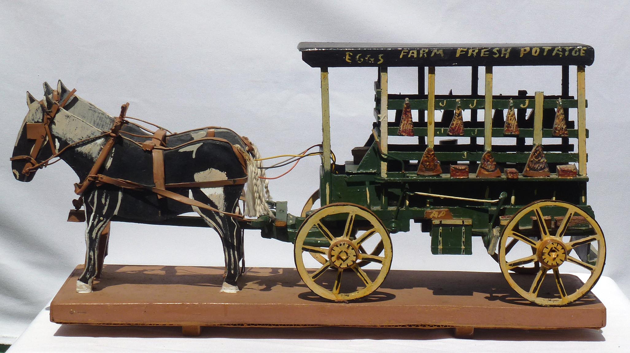 Carved farm wagon by Jim Popso