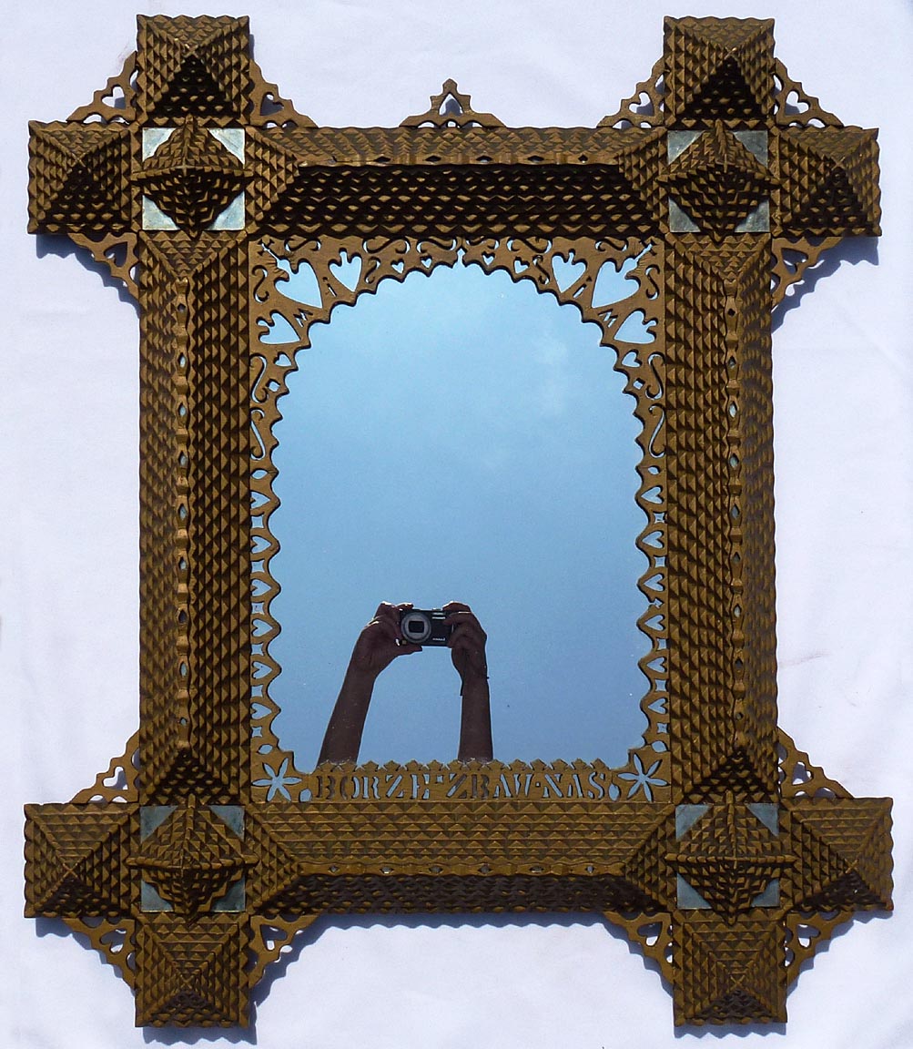 Large, intricate tramp art frame