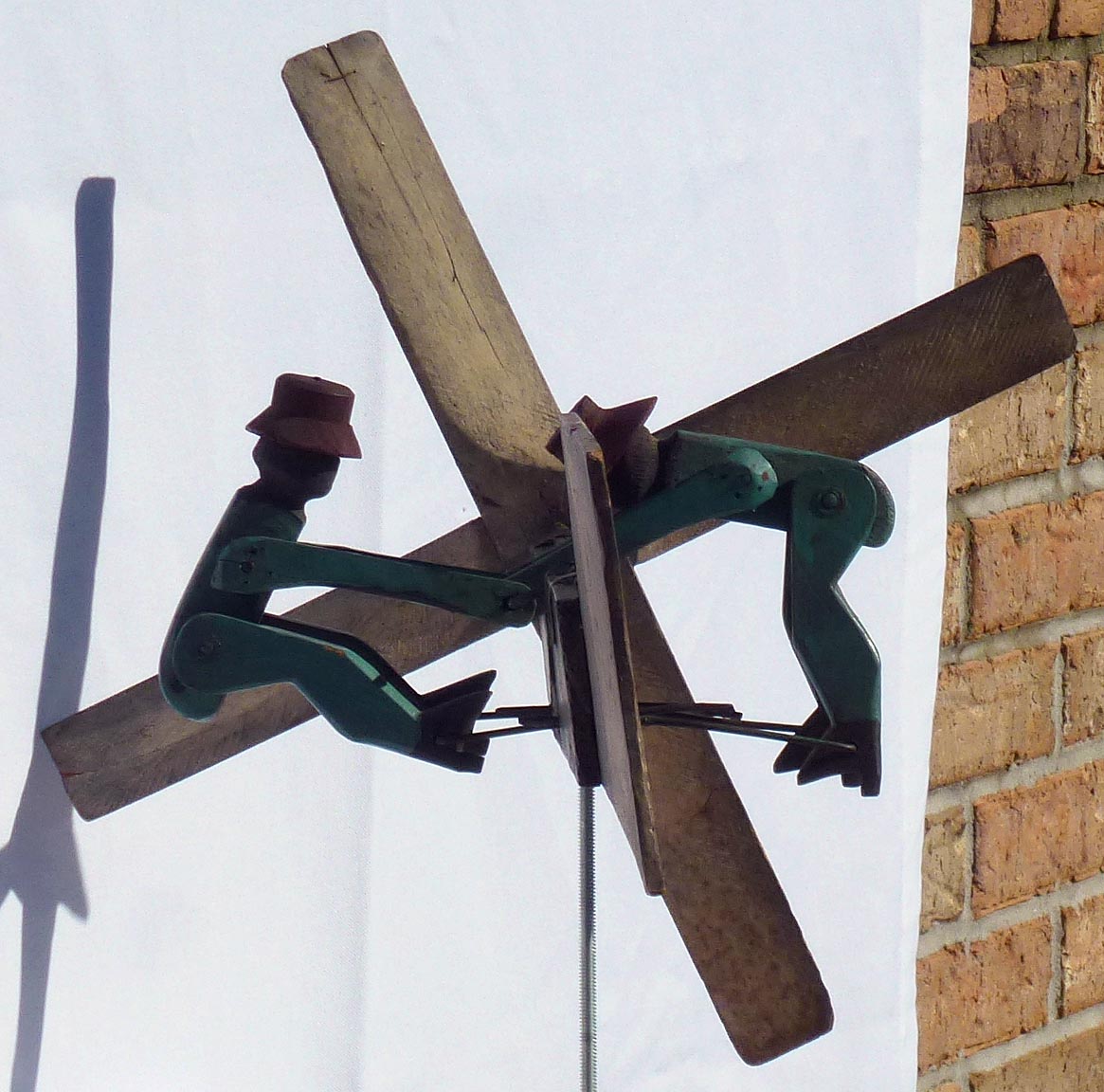 Whirligig of Two Figures Turning a Crank