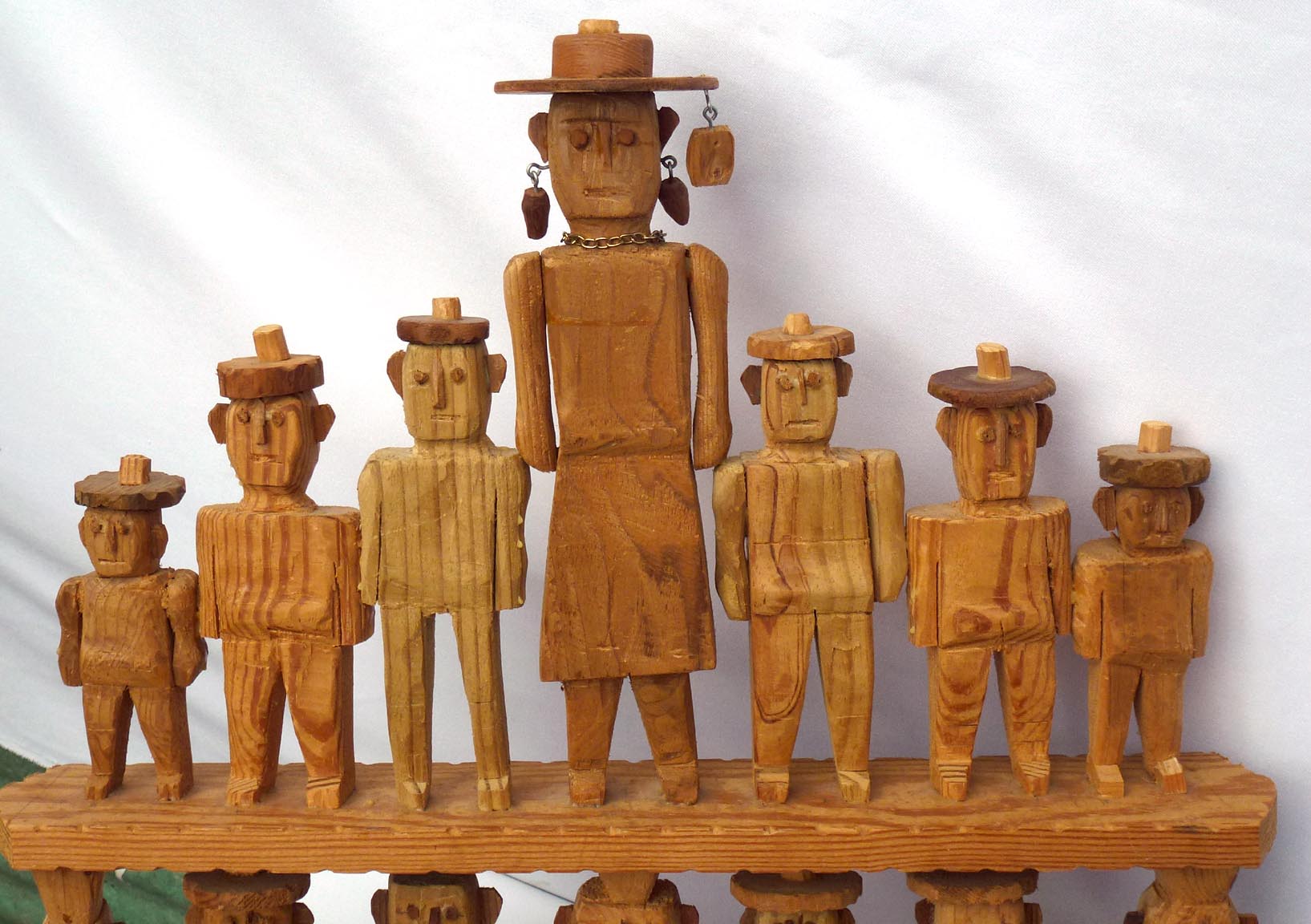 14 primitively carved people