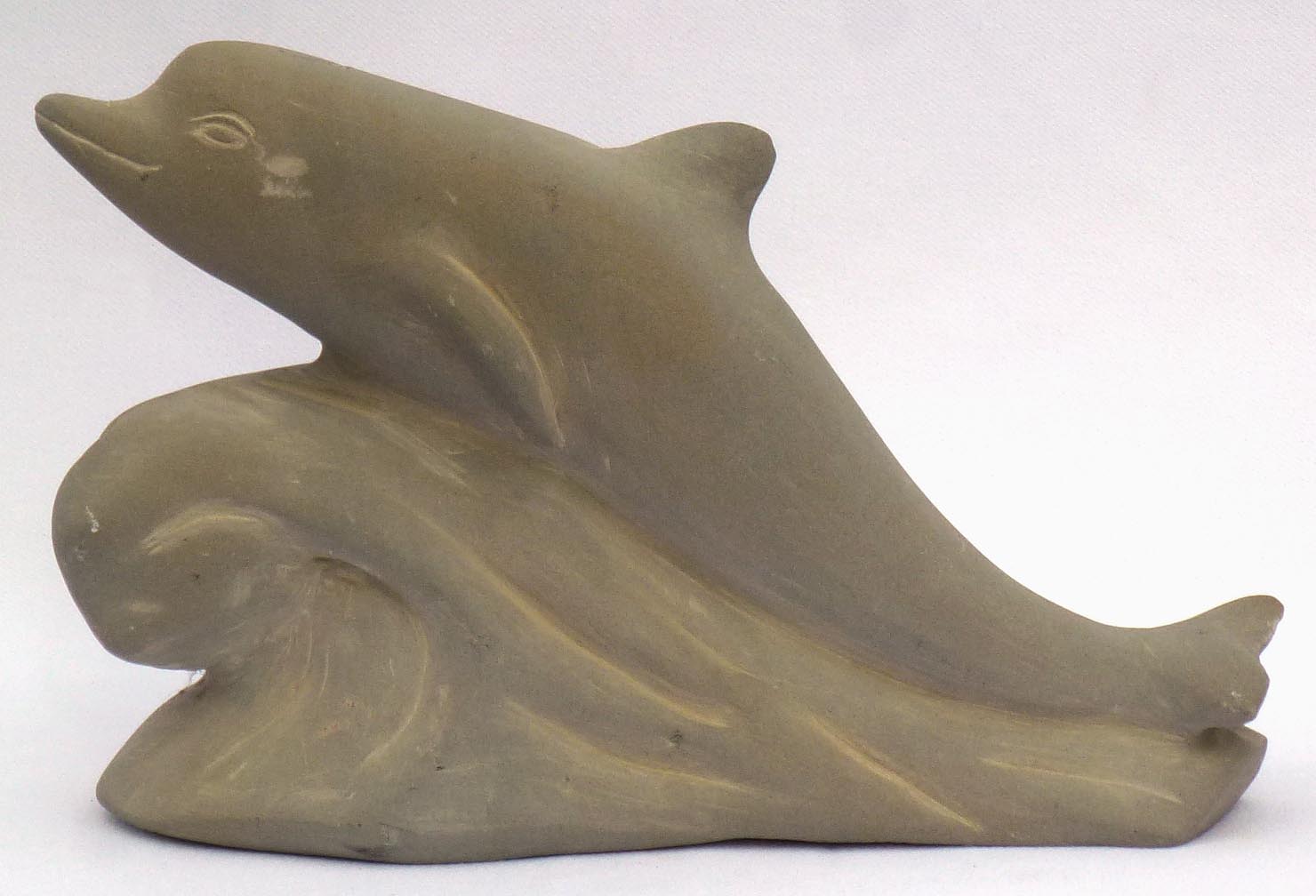 Carved stone dophin by Stanley Greer