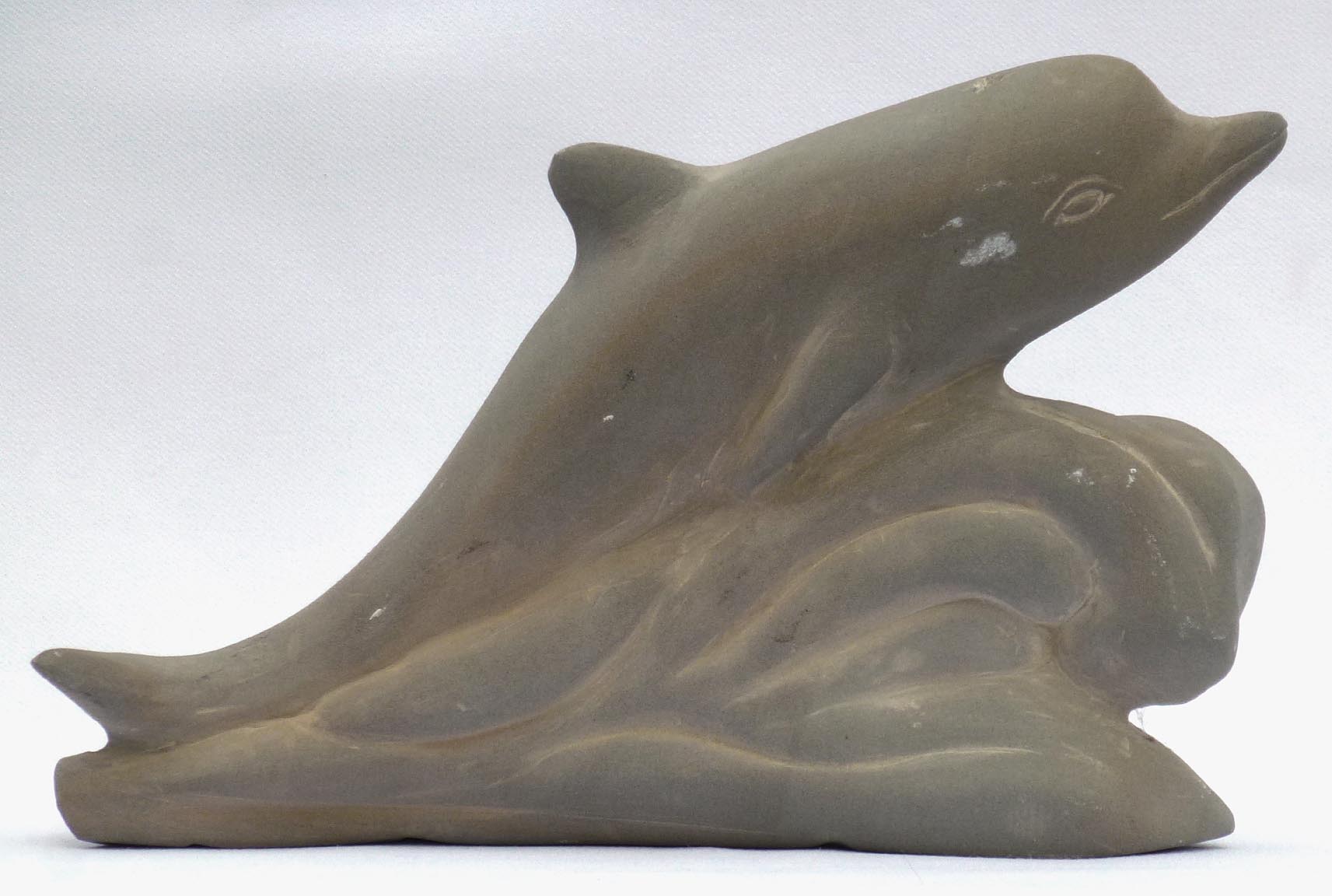 Carved stone dophin by Stanley Greer