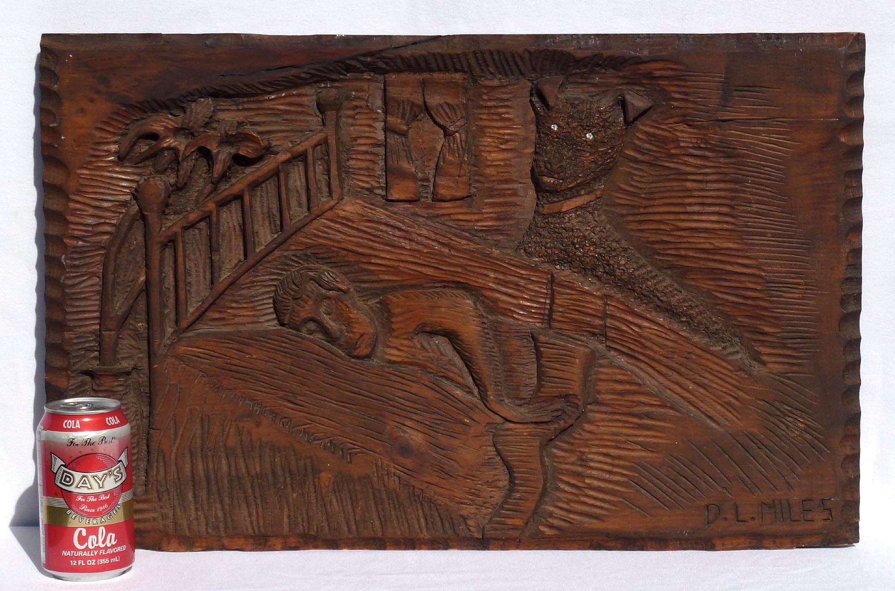 Carving of sleeping man with dog
