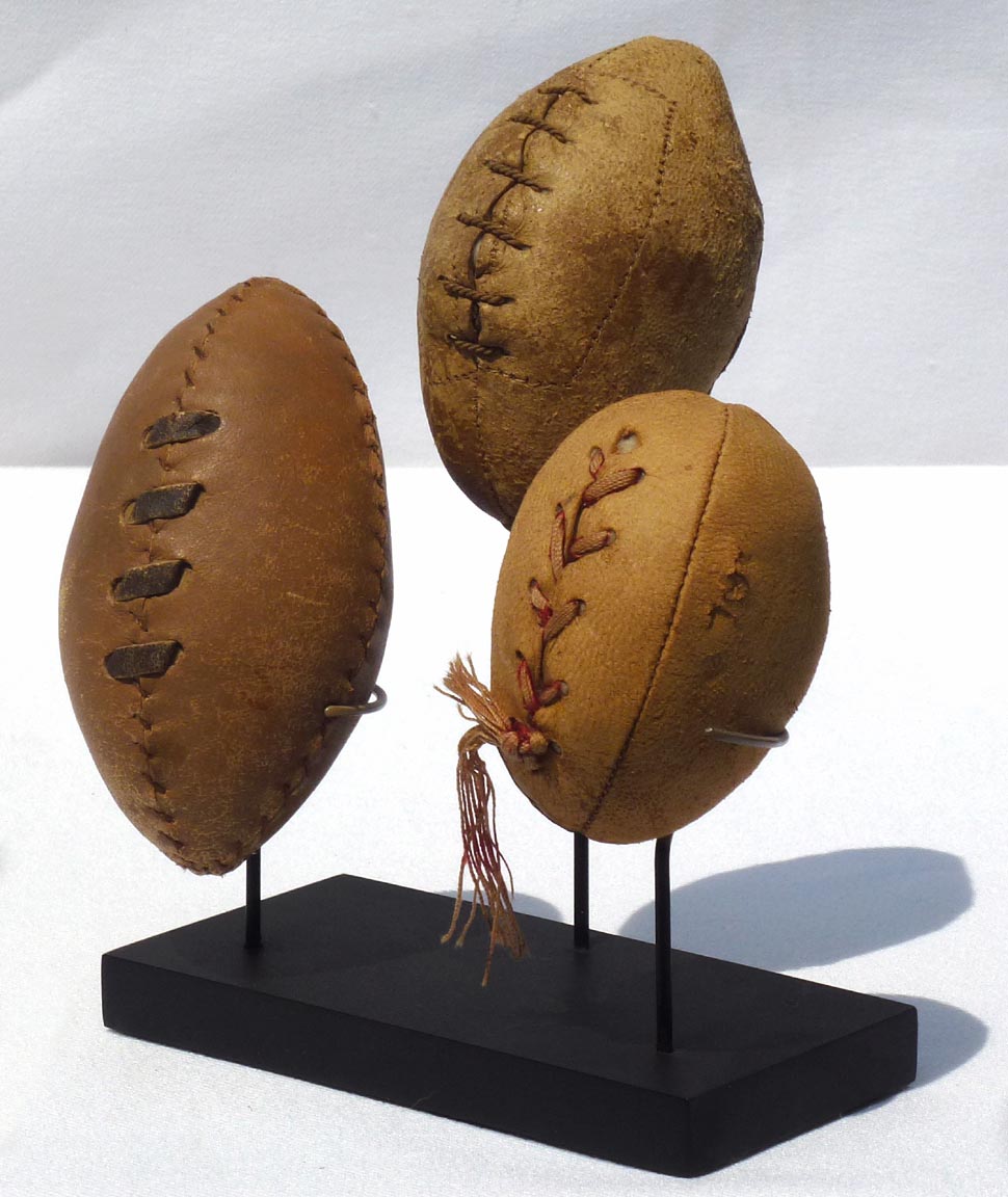 Three hand made miniature footballs