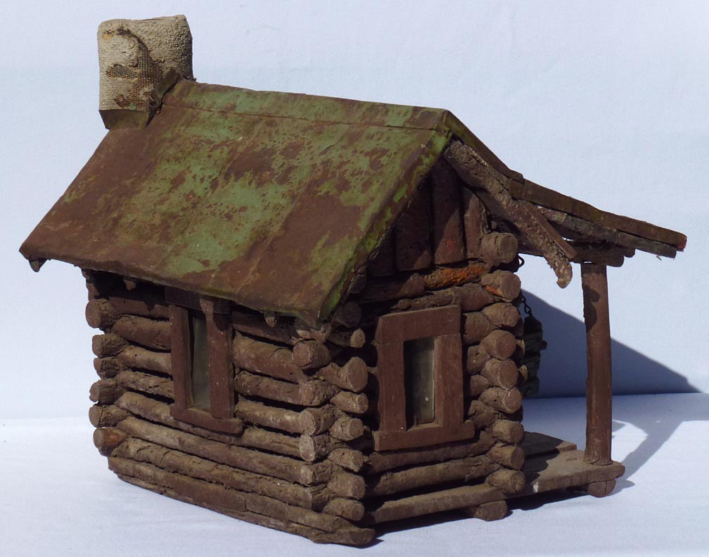 A very detailed miniature log cabin complete with porch swing. Early ...