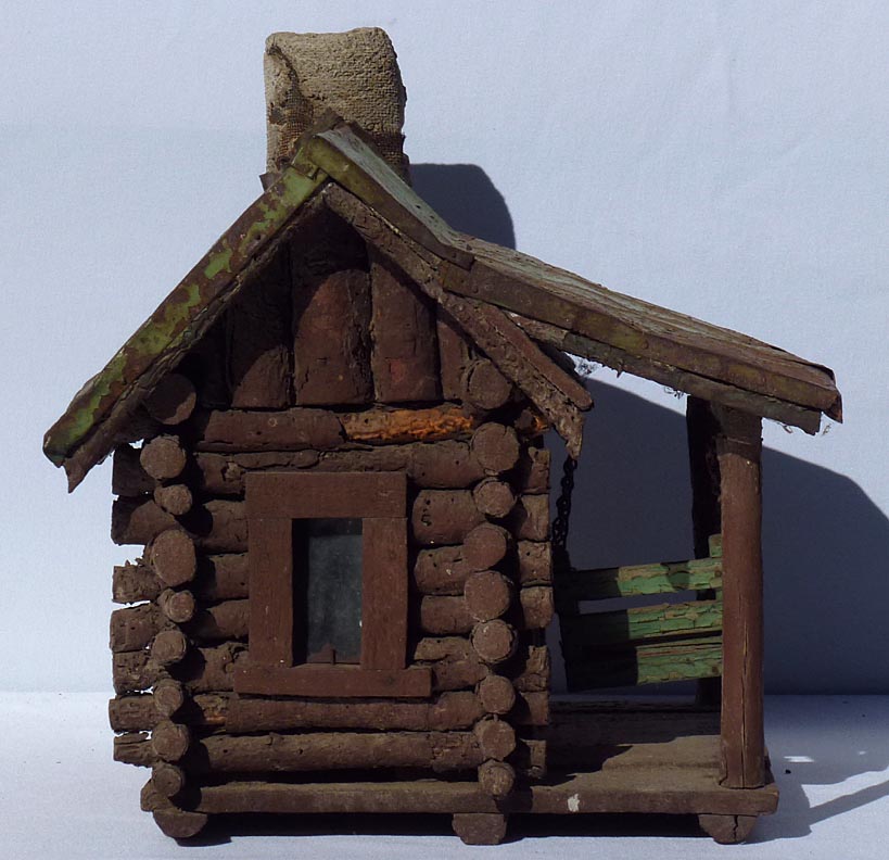 A very detailed miniature log cabin complete with porch swing. Early ...